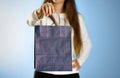 Girl holding a blue gift bag. Close up. Isolated background Royalty Free Stock Photo