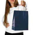 Girl holding a blue gift bag. Close up. Isolated on white background Royalty Free Stock Photo