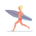 Girl holding board in hands, runs along beach in swimsuit. Royalty Free Stock Photo