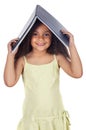 Girl holding book on head Royalty Free Stock Photo