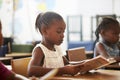 Girl holding book and reading in an elementary school lesson Royalty Free Stock Photo