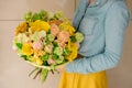 Girl holding Bouquet of the different mixed orange flowers Royalty Free Stock Photo
