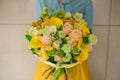 Girl holding Bouquet of the different mixed orange flowers Royalty Free Stock Photo