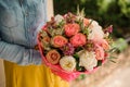 Girl holding Bouquet of the different mixed orange and white flowers Royalty Free Stock Photo