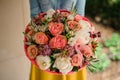 Girl holding Bouquet of the different mixed orange and white flowers Royalty Free Stock Photo