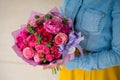 Girl holding bouquet of a mixed pink and purple flowers Royalty Free Stock Photo