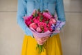 Girl holding bouquet of a mixed pink and purple flowers Royalty Free Stock Photo