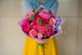 Girl holding bouquet of a mixed pink and purple flowers Royalty Free Stock Photo