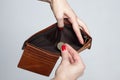 The girl is holding a brown purse with one Euro coin. the concept of poverty Royalty Free Stock Photo