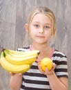 Girl holding a bunch of bananas and lemon Royalty Free Stock Photo