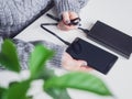 The girl is holding a cable connecting the phone and power bank. A woman charges her smartphone using powerbank. Portable charger Royalty Free Stock Photo