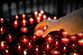 A girl is holding candle and praying near altar in church. Royalty Free Stock Photo