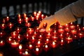 A girl is holding candle and praying near altar in church. Royalty Free Stock Photo