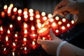 A girl is holding candle and praying near altar in church. Royalty Free Stock Photo