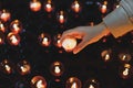 A girl is holding candle and praying near altar in church. Royalty Free Stock Photo