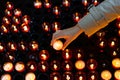 A girl is holding candle and praying near altar in church. Royalty Free Stock Photo