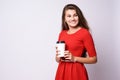 Girl holding coffee. Red dress. White glass Royalty Free Stock Photo
