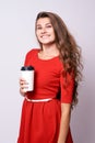 Girl holding coffee. White glass. Red dress Royalty Free Stock Photo