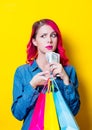 Girl holding a colored shopping bags and money Royalty Free Stock Photo