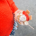 Girl holding colorful handmade ice cream cup with strawberry and marshmallows outdoors Royalty Free Stock Photo