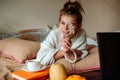 Girl holding a cup of hot coffee in bed.Cozy autumn Royalty Free Stock Photo