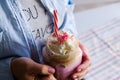 Girl is holding cup of pink coffee with cream, marshmallow and decoration. Milk shake, cocktail. Unicorn coffee, unicorn food. Royalty Free Stock Photo