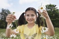 Girl Holding Daisy Chains In Meadow Royalty Free Stock Photo