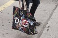 A girl holding a Dolce and Gabbana bag