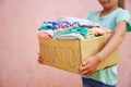 Girl holding donation box with clothes Royalty Free Stock Photo