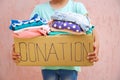 Girl holding donation box with clothes Royalty Free Stock Photo