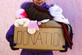 Girl holding donation box with winter clothes