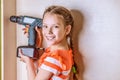 Girl holding a drill Royalty Free Stock Photo