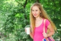 Girl is holding drink in the park Royalty Free Stock Photo