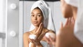 Girl Holding Face Cream Product Hydrating Skin In Bathroom Royalty Free Stock Photo