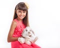 Girl holding flap-eared rabbit against white