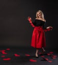 Girl holding a garland heart Valentine, happiness, on the floor hearts wedding. shape. emotion, black in red dress girl