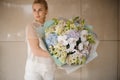 Girl holding giant bouquet of different flowers Royalty Free Stock Photo