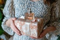 Girl holding a gift box and a bottle of perfume in her hands Royalty Free Stock Photo