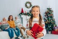 Girl holding gift box and looking