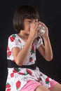 Girl is holding a glass of water