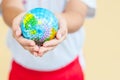 A girl is holding the globe, saving the world