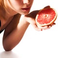 Girl holding grapefruit half