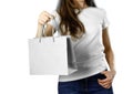 Girl holding a gray paper gift bag. Close up. Isolated background Royalty Free Stock Photo