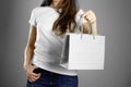 Girl holding a gray paper gift bag. Close up. Isolated background Royalty Free Stock Photo