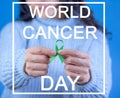 Girl holding green ribbon in support of liver and adrenal cancer, Text with the legend \