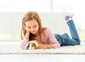 Girl holding guinea pig on the floor Royalty Free Stock Photo