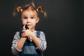 Girl holding a guinea pig in her arms, on a black background Royalty Free Stock Photo