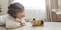 A girl holding a guinea pig in her arms, on a black background. a lot of joy and fun Royalty Free Stock Photo