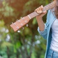 Girl holding guitar chill out in the garden Royalty Free Stock Photo