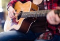 Girl holding guitar. Focus on strings of guitar Royalty Free Stock Photo